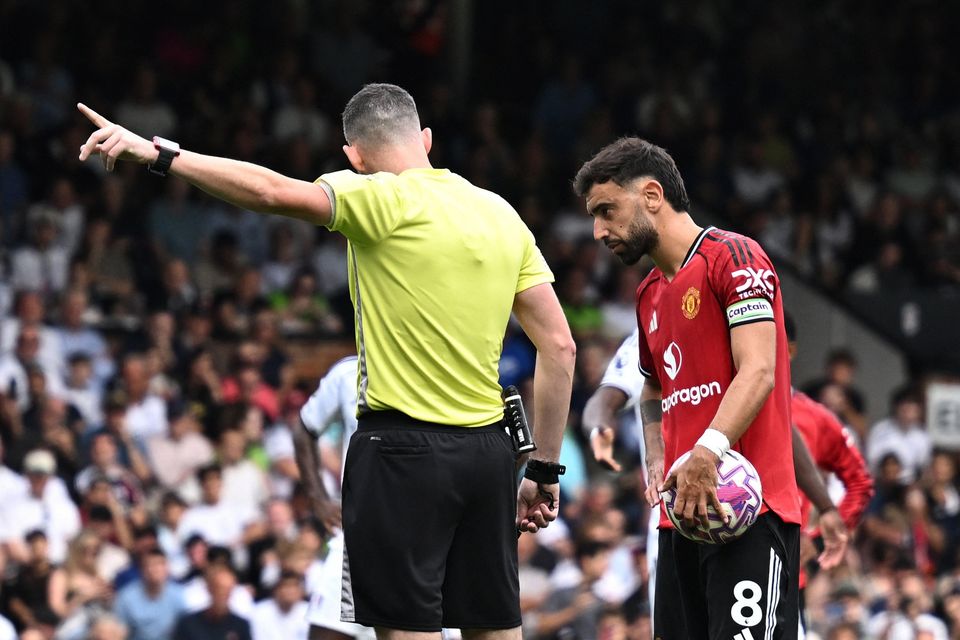 Referee Chris Kavanagh gestures as Manchester United's Bruno Fernandes prepares to take a penalty kick in the Premier League draw with Fulham at Craven Cottage, London